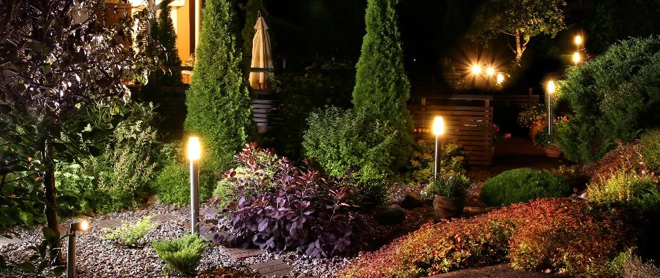 Landscape bed in Huron, OH, with plants and outdoor lighting.
