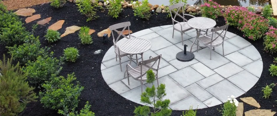 Mulched landscaping around a concrete paver patio in Huron, OH.