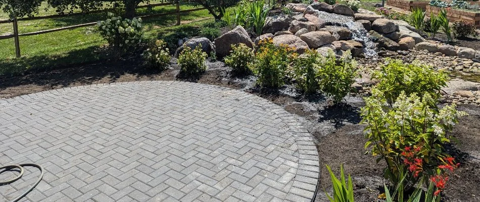 Patio in Huron, OH, with a herringbone paver pattern.