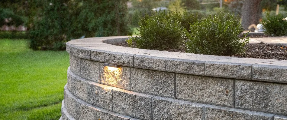 Retaining wall in Huron, OH, with a raised planter bed.