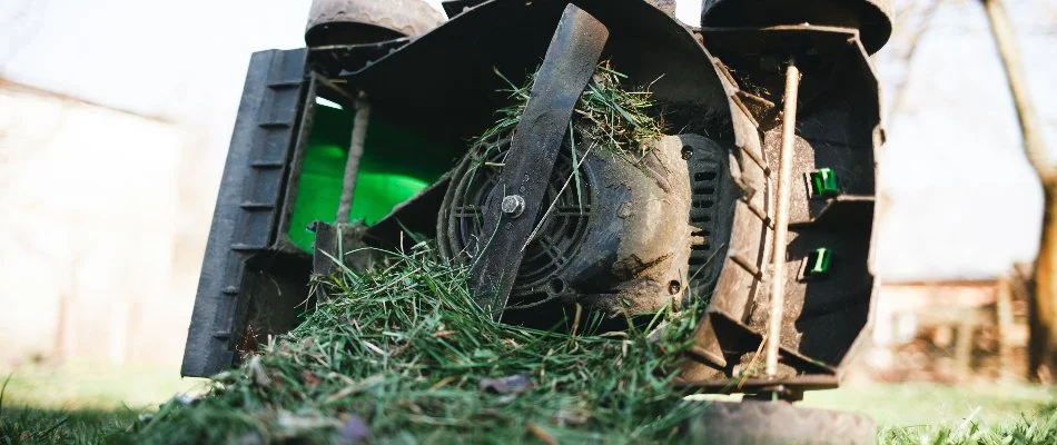 Wet grass causing a clogged mower in Huron, OH.