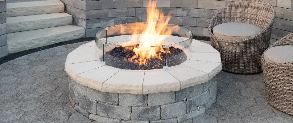 Circular fire pit with flames on a property in Huron, OH.