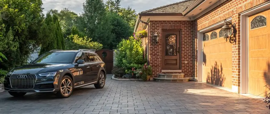 Elegant home with a spacious stamped concrete driveway, lush landscaping, and a well-maintained front yard in Huron, OH.