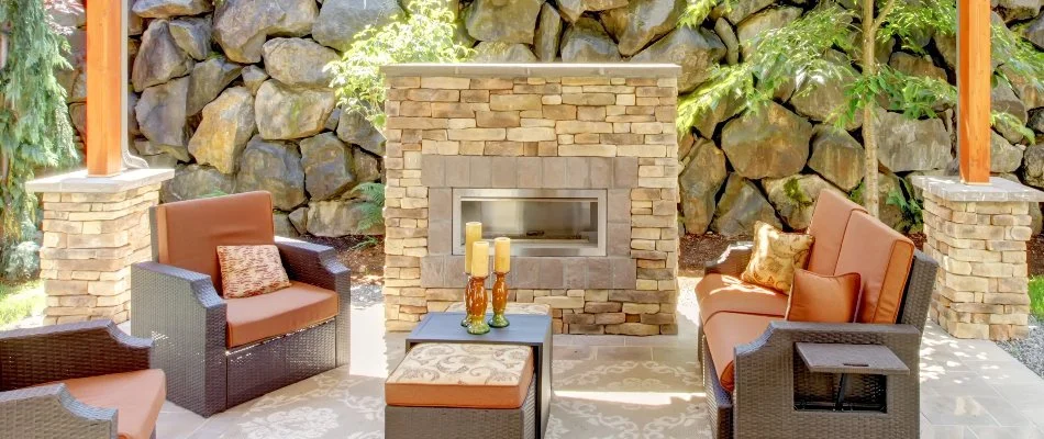 Gas-burning outdoor fireplace with outdoor chairs in Huron, OH.