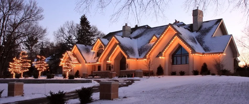 Holiday lights on a house in Erie County, OH, and snow.