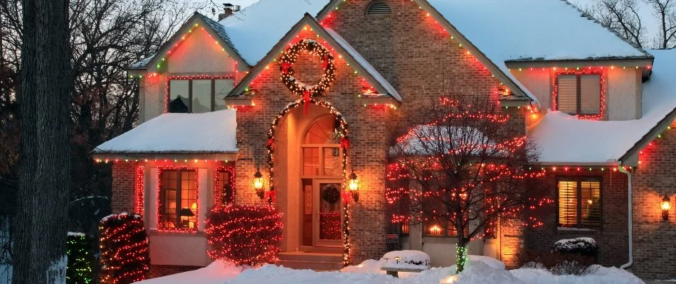 House in Lorain, OH, with red holiday lights.