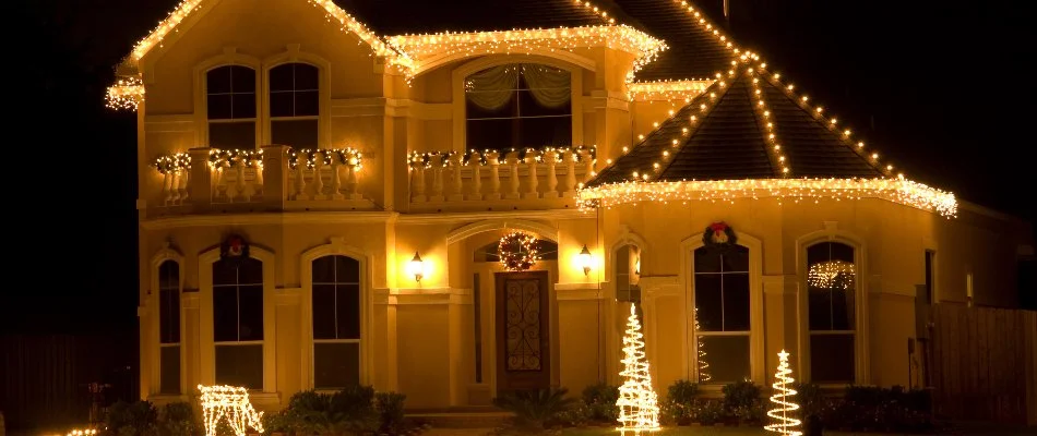 House in Middle Bass, OH, with warm white holiday lighting.