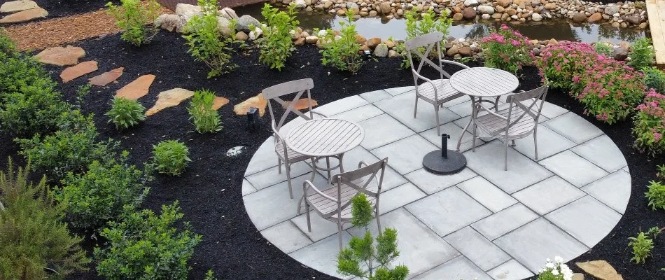 Landscaping with plants and flowers in Lorain, OH, around a patio.