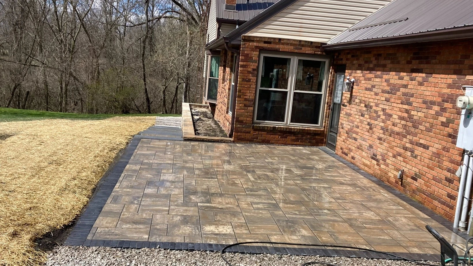Paver patio in Huron, OH, at the back of a house.