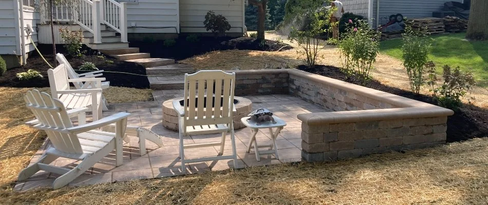 Patio in Huron, OH, with seating wall and fire pit.