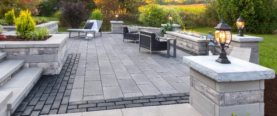 Paver patio in Lakeside, OH, with chairs and a fire pit.