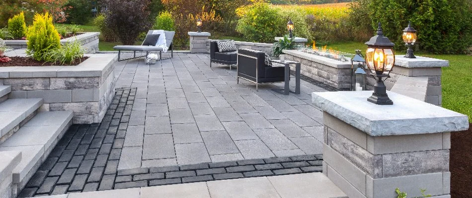 Paver patio in Erie County, OH, with a fire pit and walls.