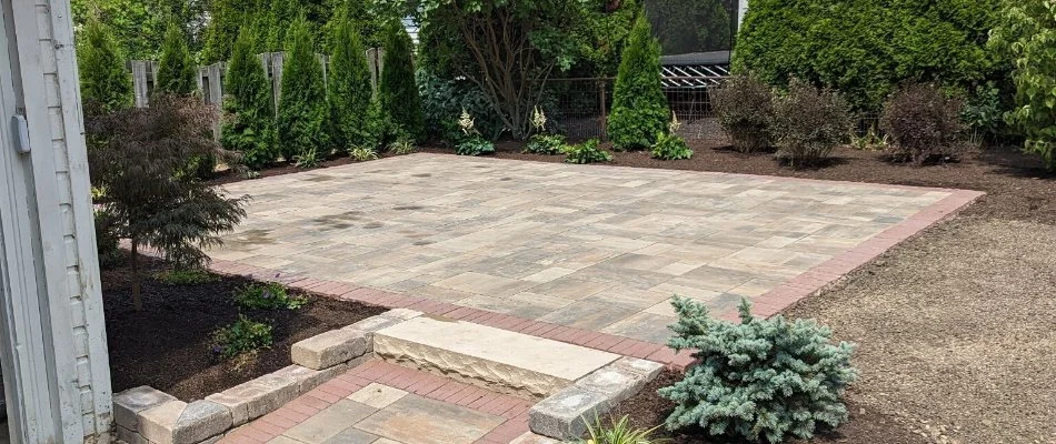 Plants around a natural stone patio in Fremont, OH.