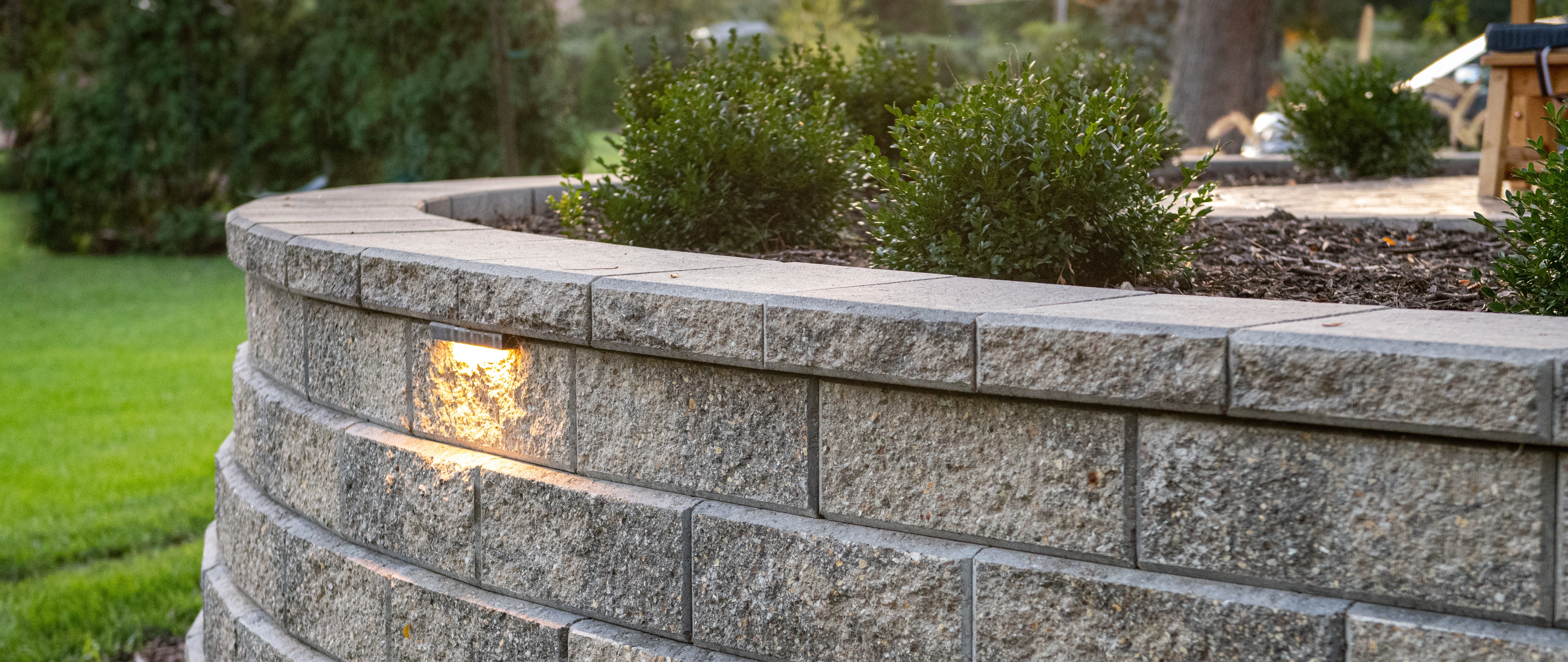 Retaining wall near a house in Huron, OH, with landscaping.