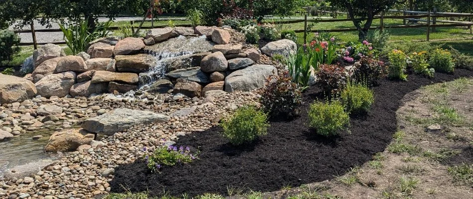 Water feature next to a landscape bed in Norwalk, OH.