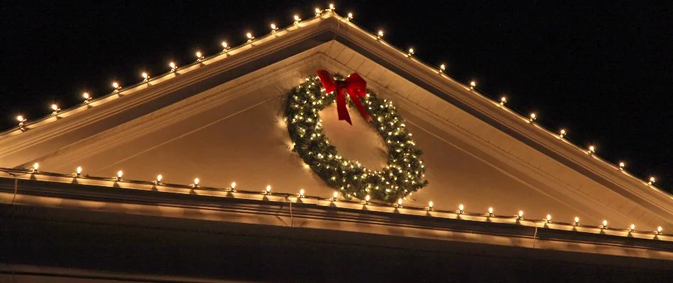 Wreath and white holiday lights on a house in Huron, OH.